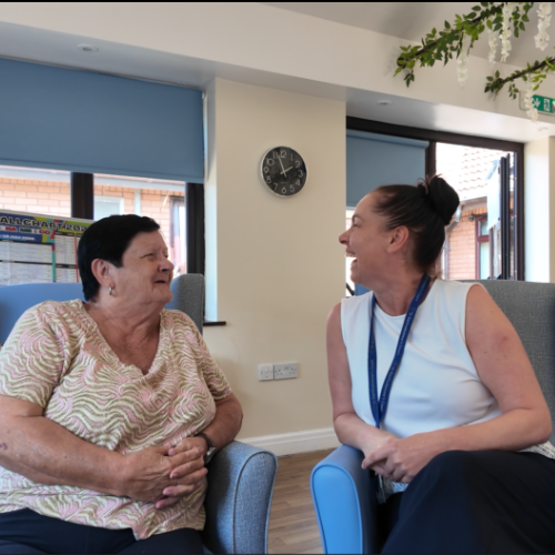 Gemma Mylett chatting with a resident in the lounge at St Bartholomew’s Court
